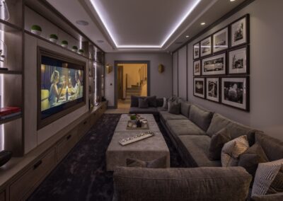Double-height basement media room with 90-inch Sony display in a Chelsea townhouse