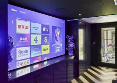 Crestron-controlled gaming and cinema room with surround sound
